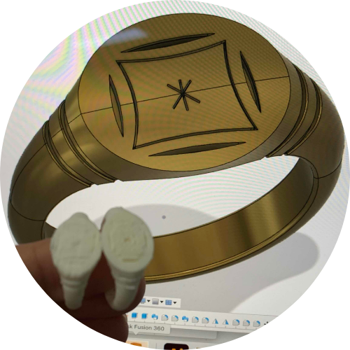 Photo of 3D printed test models of bronze ring design